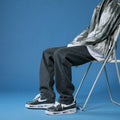 Men's straight leg loose jeans in dark blue cotton denim with mid waist and slight stretch