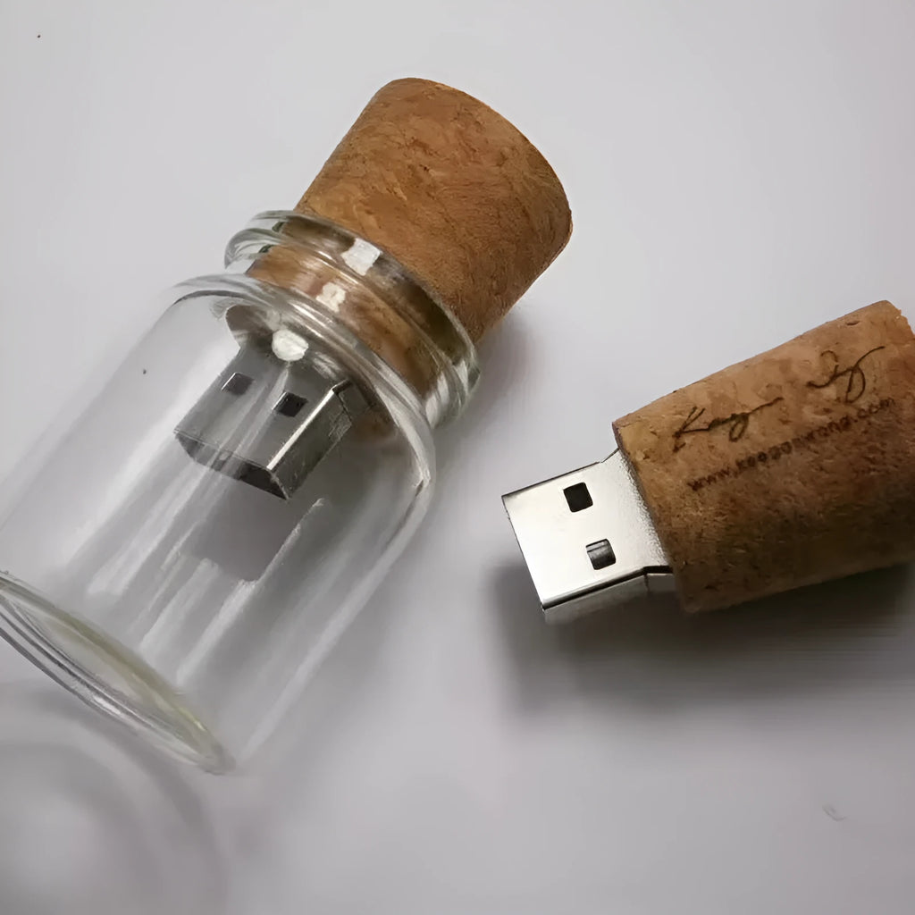 Wooden and transparent glass bottle-shaped USB flash drive on a wooden surface.