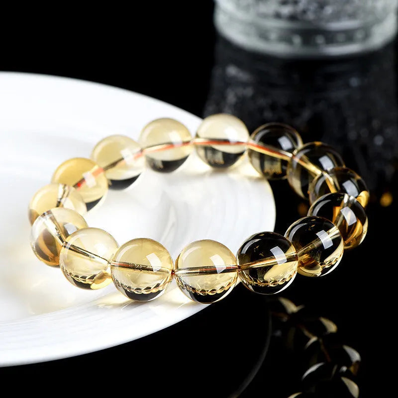 Adjustable natural citrine scattered beads bracelet on a wrist, showing polished yellow gemstones in an organic pattern.