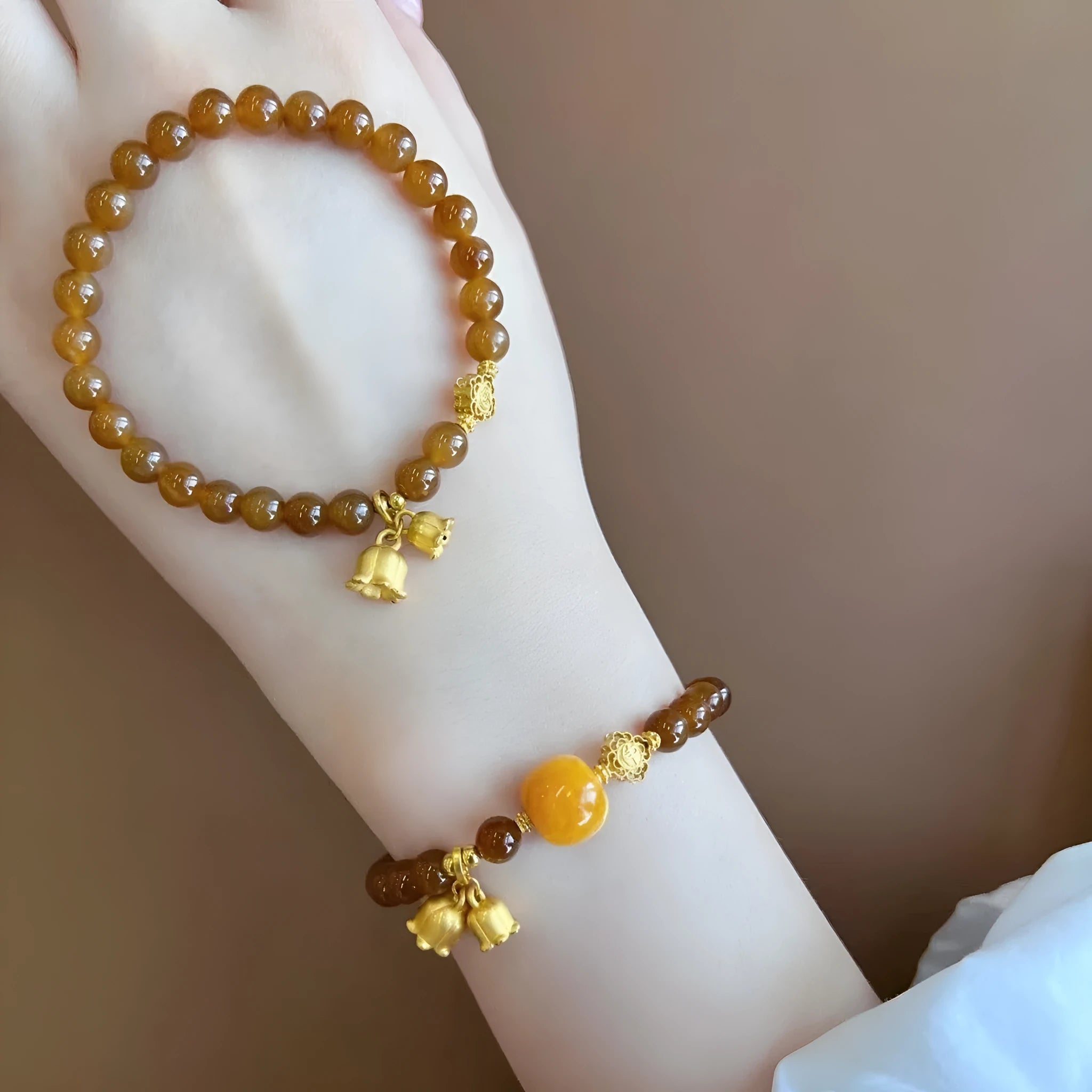 Caramel coloured electroplated women's bracelet with Lily flower design in mixed materials.