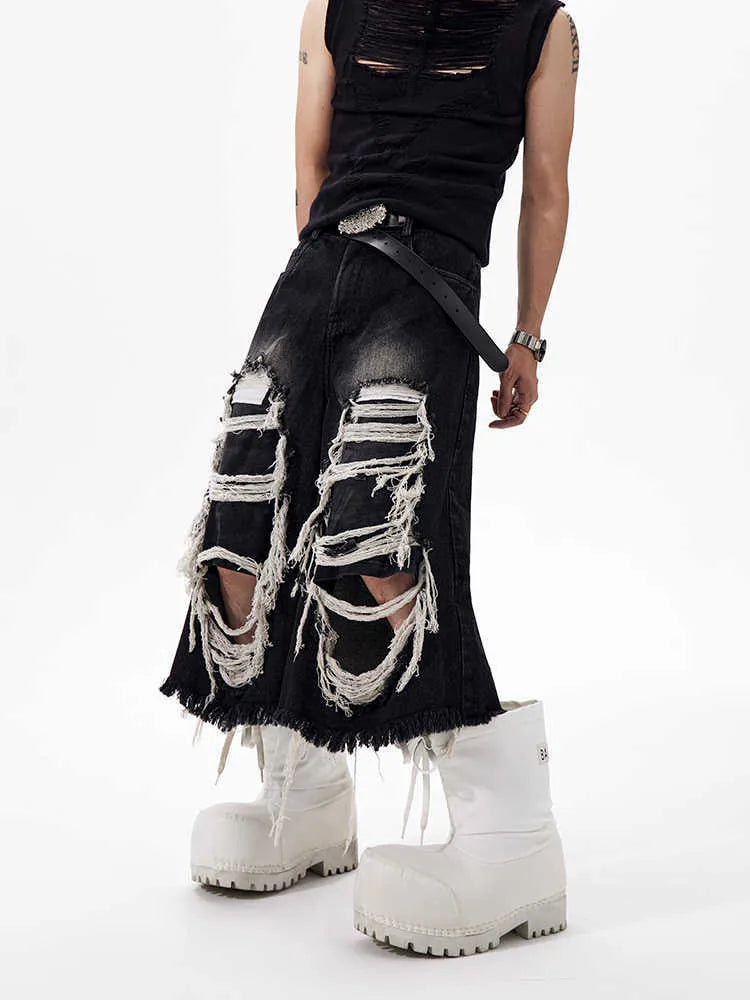 Black wide leg cropped jeans with distressed patch details on the legs, showing a mid-high waist.