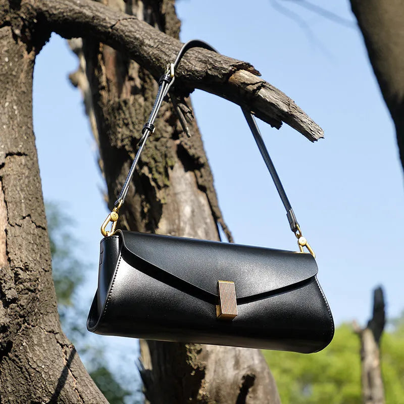 Women's leather cross-body bag with clamshell design and pillow shape in multiple colours