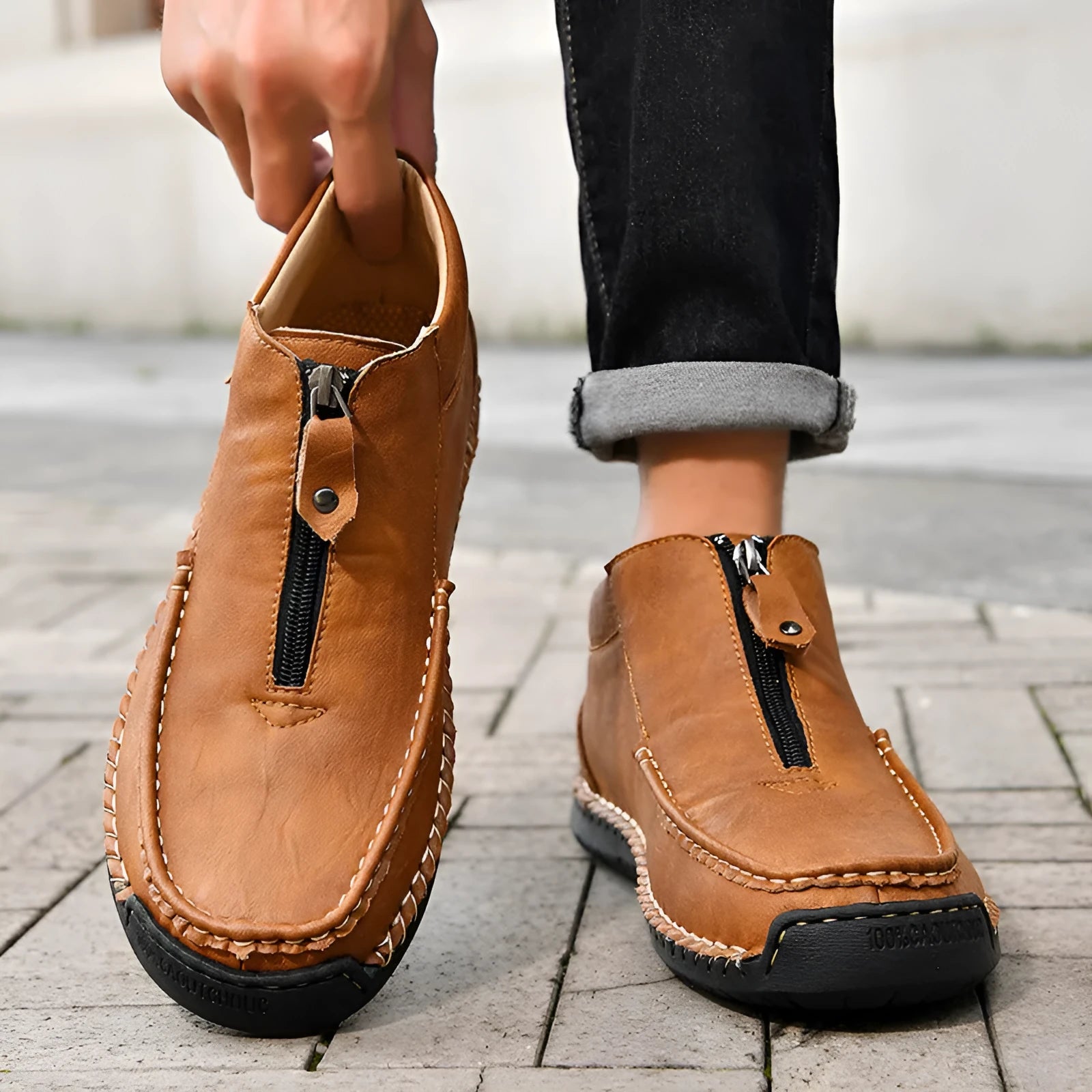 Men's black slip-on loafers with a round toe and low rubber sole.