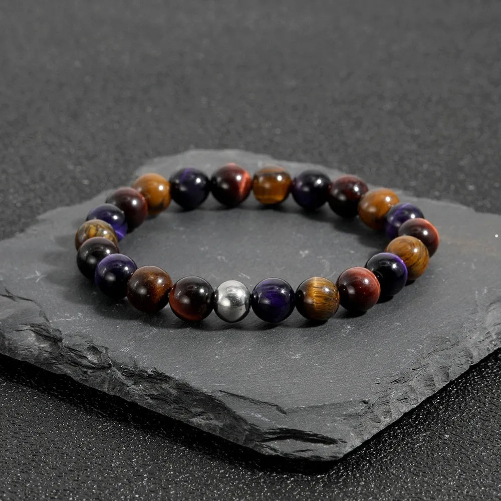 Handmade elastic tiger-eye stone bracelet showing yellow purple red colours in geometric pattern
