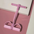 Yoga four-piece set with leg stretching device, yoga ring, pedal puller, and figure-eight tension rope on a grey background.