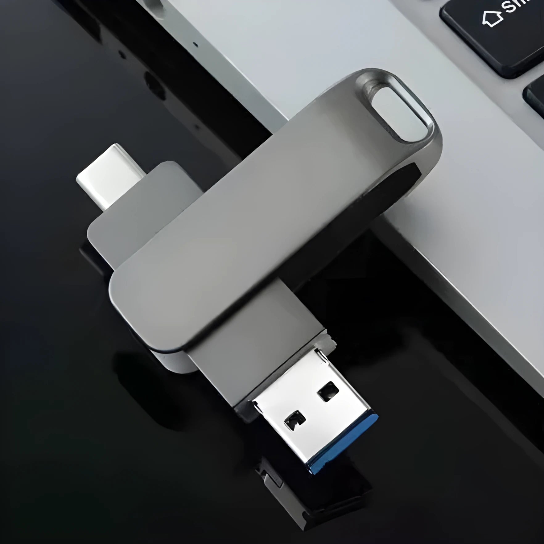 Rotating metal USB flash drive showing black and silver colour options with Type-C and standard USB connectors