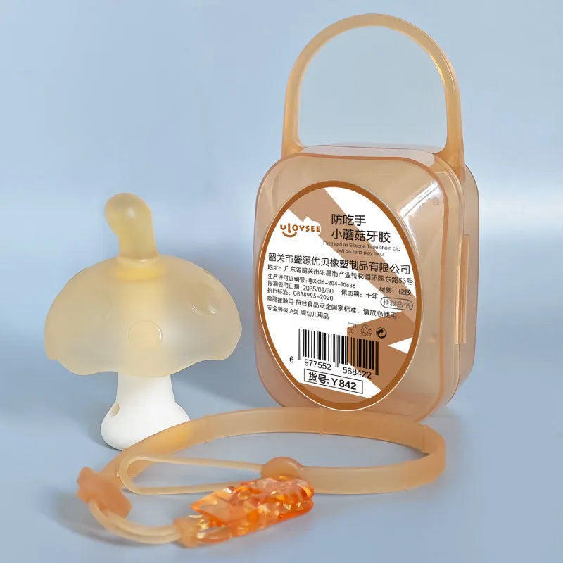Small pink mushroom-shaped silicone chew pendant on a thin silver-coloured breakaway necklace.