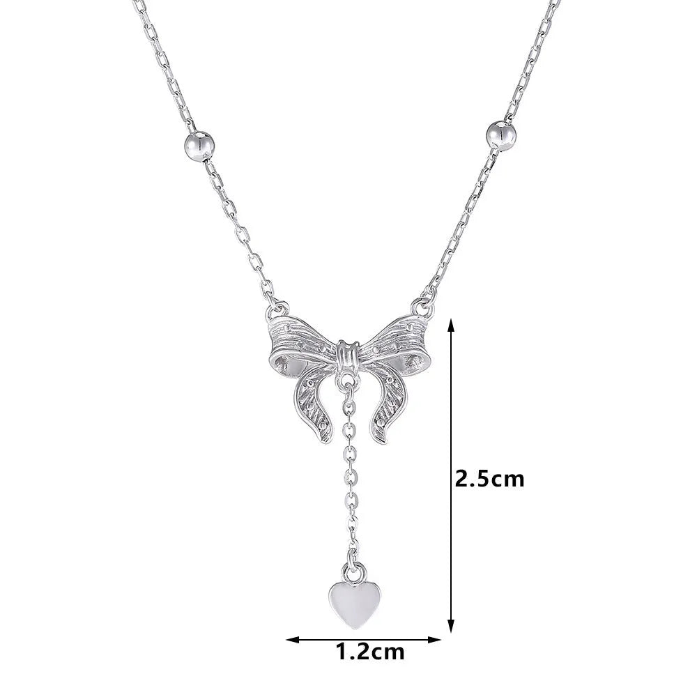 S925 sterling silver necklace with heart and bow pendant on an adjustable O-ring chain.