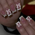 Set of 24 white French manicure false nails with bow and tulip designs, next to bottles of S274 glue and jelly glue.
