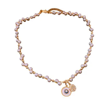 Gold-plated necklace with round pearl pendant and zircon accents on adjustable chain