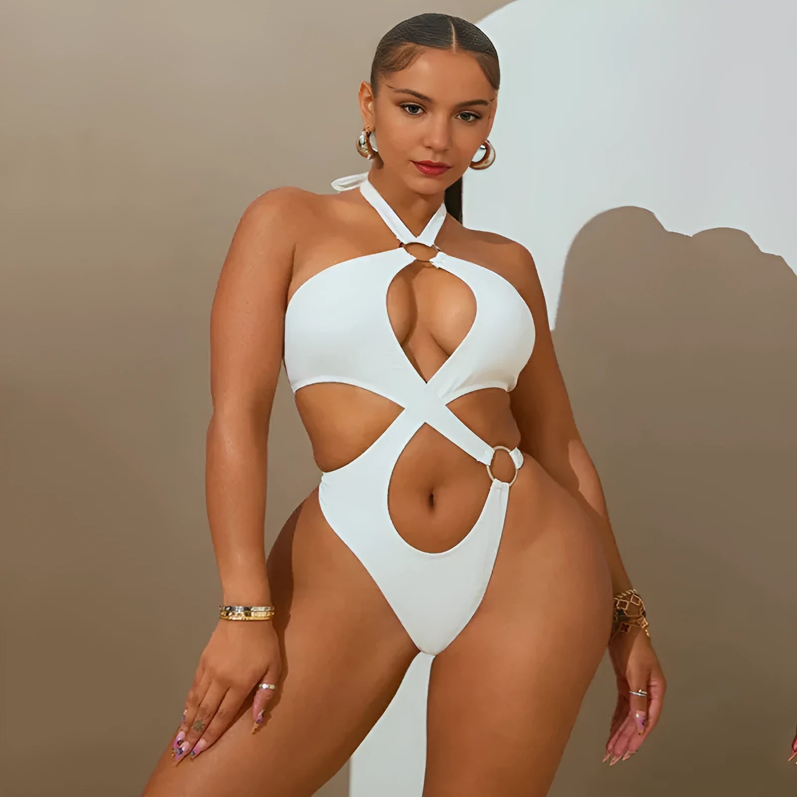Women's white sleeveless jumpsuit with back lace-up detail and tapered shorts.