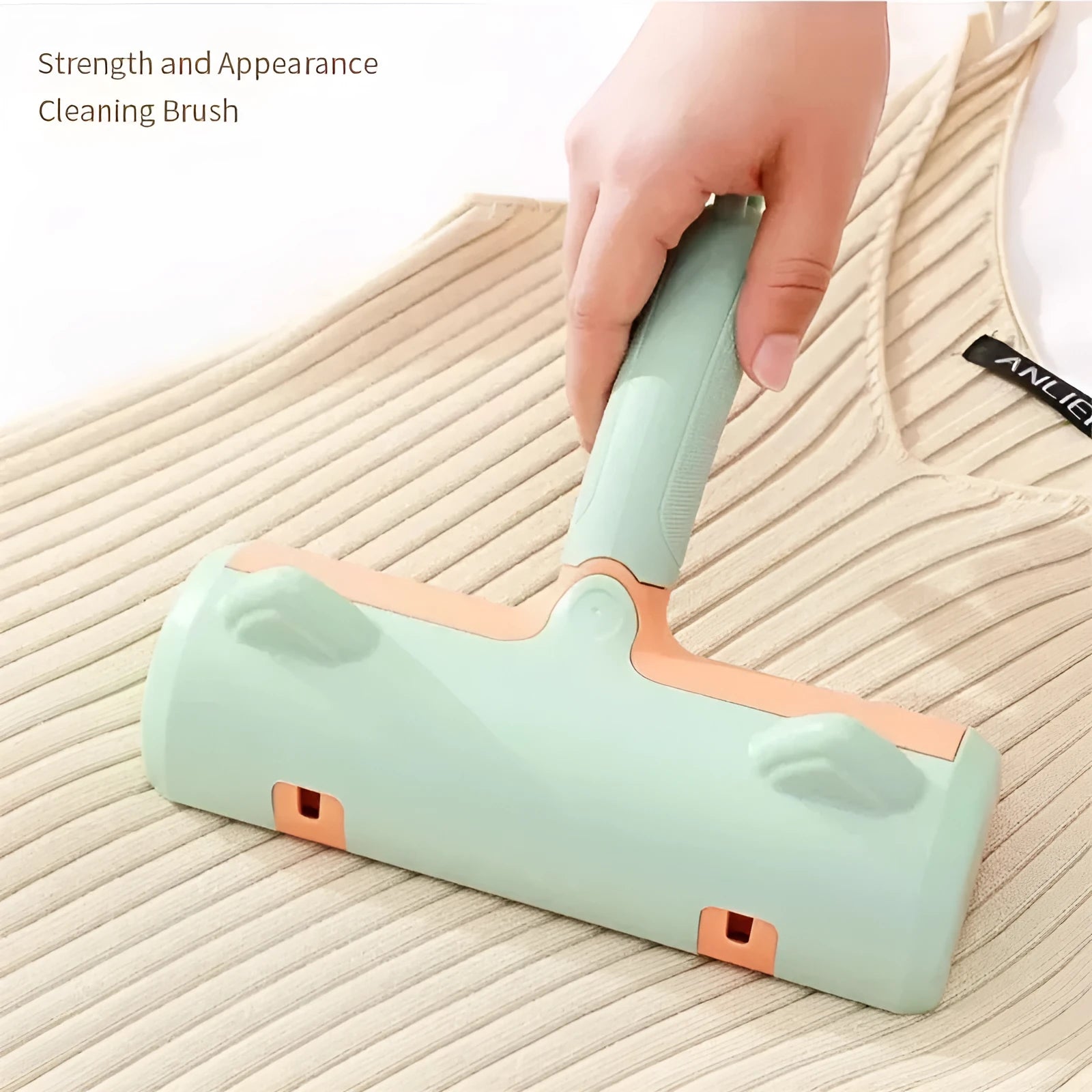 Gray self-cleaning two-way pet hair roller brush with non-slip handle on fabric surface