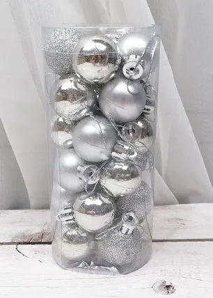 Assorted shiny red, gold, silver, and blue 3 cm Christmas baubles in a box and a storage barrel.