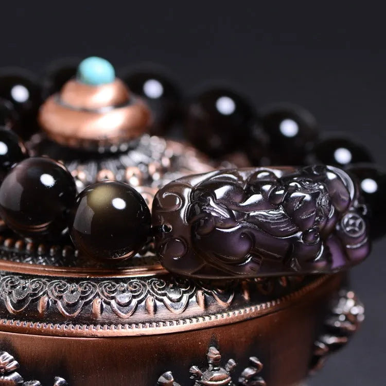 Polished crystal Pi Xiu bracelet with geometric beads on wrist, showing ice stone colour.