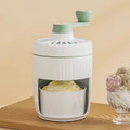 Hand-cranked ice shaving machine in green, compact portable design with removable ice box and stainless steel blade