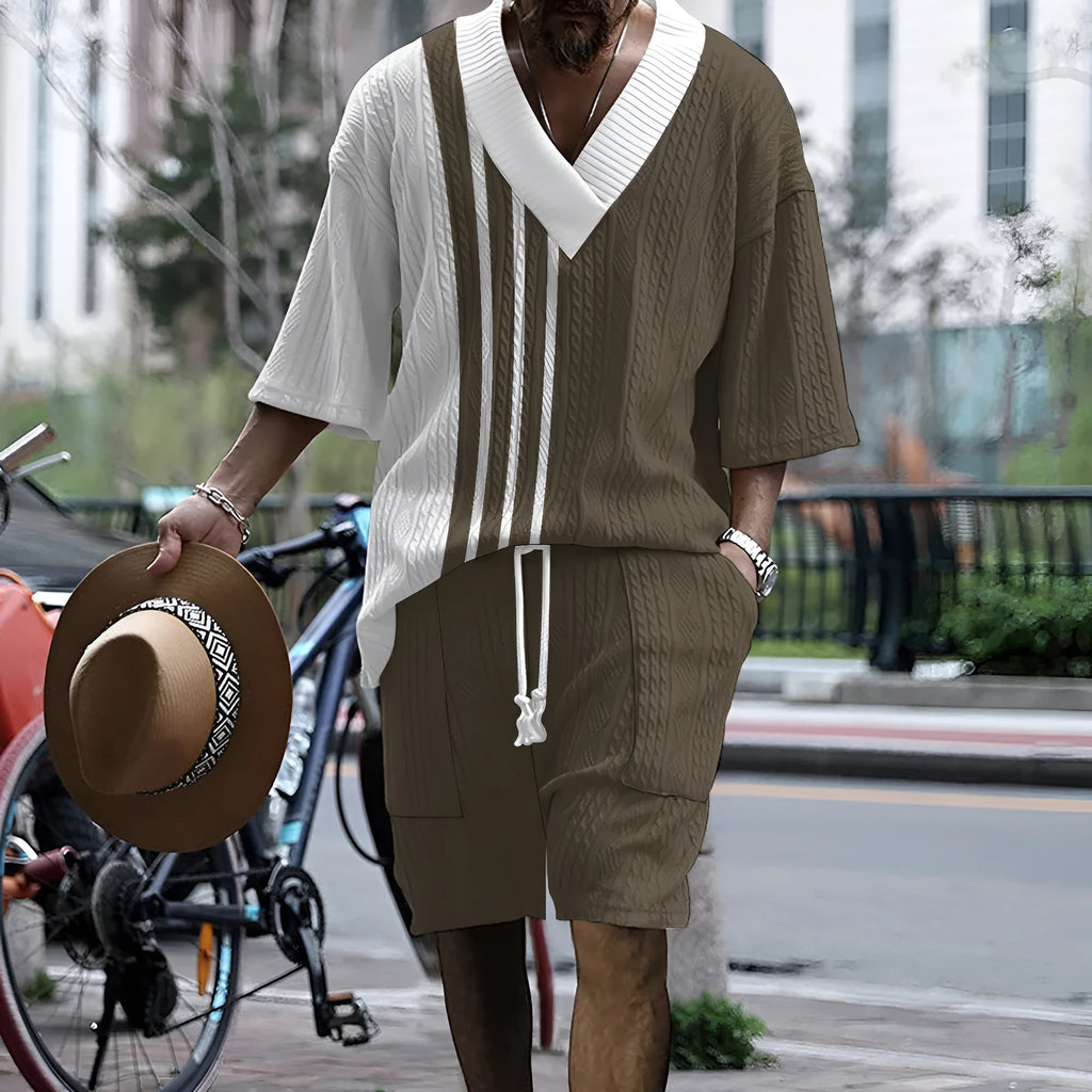 Man modelling a printed drop-shoulder knitted short-sleeved top with matching shorts in a casual setting.