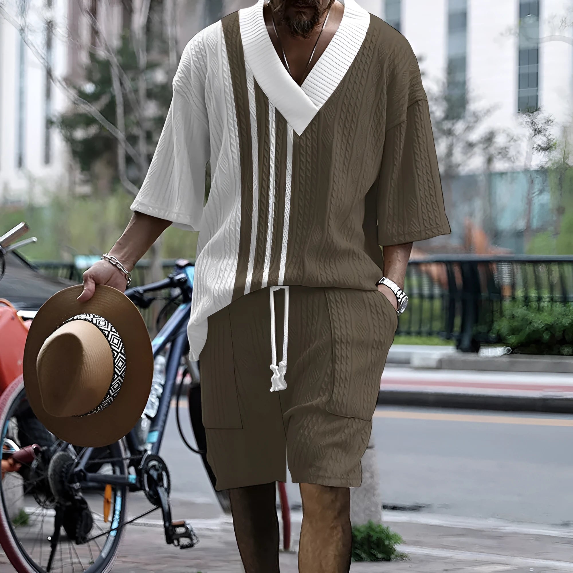 Man modelling a printed drop-shoulder knitted short-sleeved top with matching shorts in a casual setting.