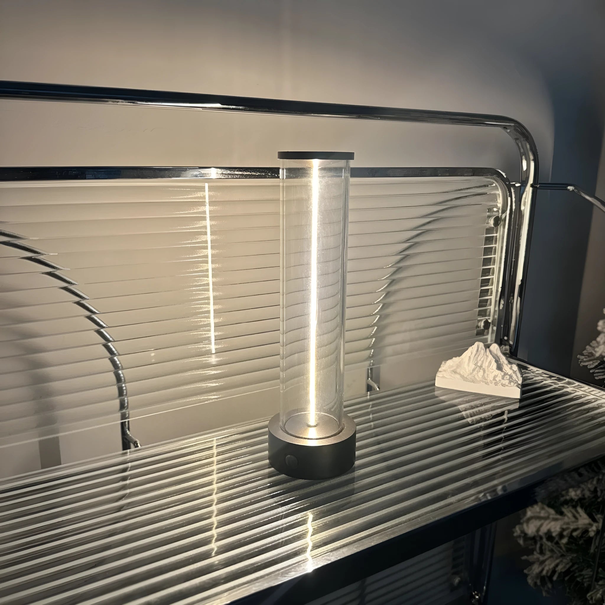 Slender glass LED light strip with magnetic base for USB charging night light.