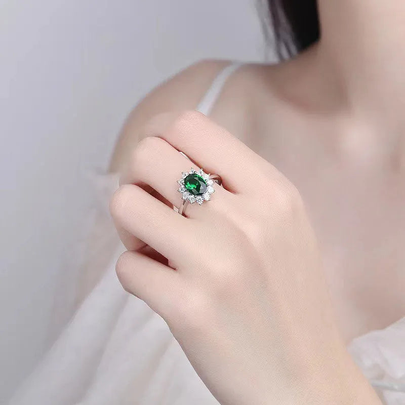Electroplated copper ring with floral shape and zirconium inlay, shown in green, blue, and red colour options.