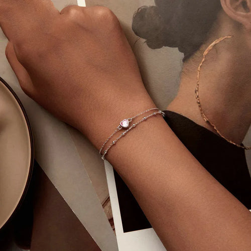 Silver heart-shaped charm bracelet for women on an adjustable chain.