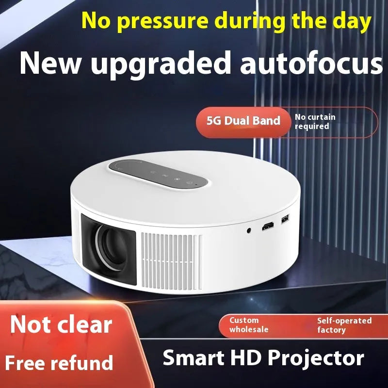 White HD home cinema projector with remote control on a table