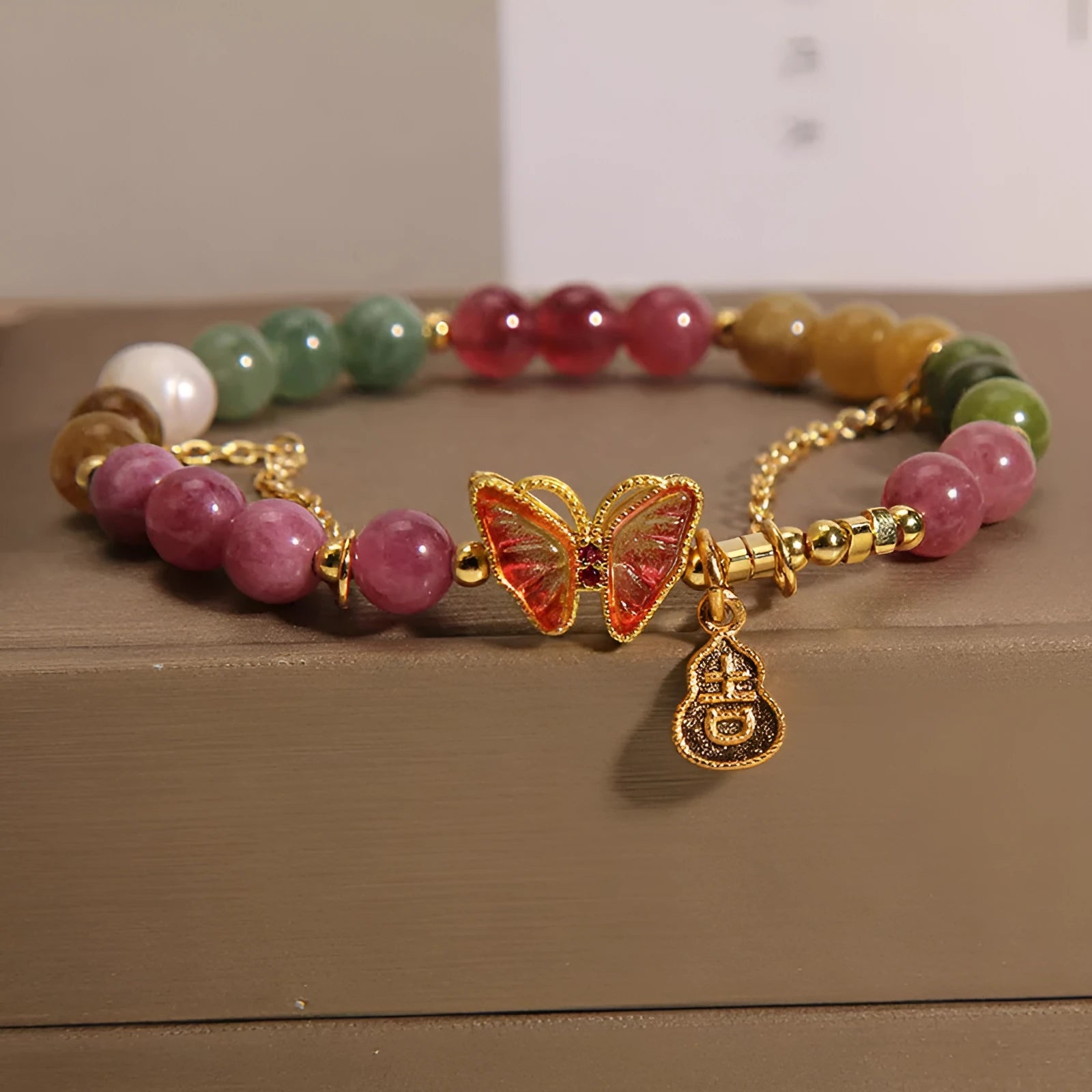 Natural jade coloured tourmaline bracelet with butterfly gourd pendant on adjustable agate bead band