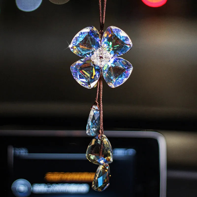 Crystal four leaf grass car pendant hanging, shown in different colour options including transparent and champagne.