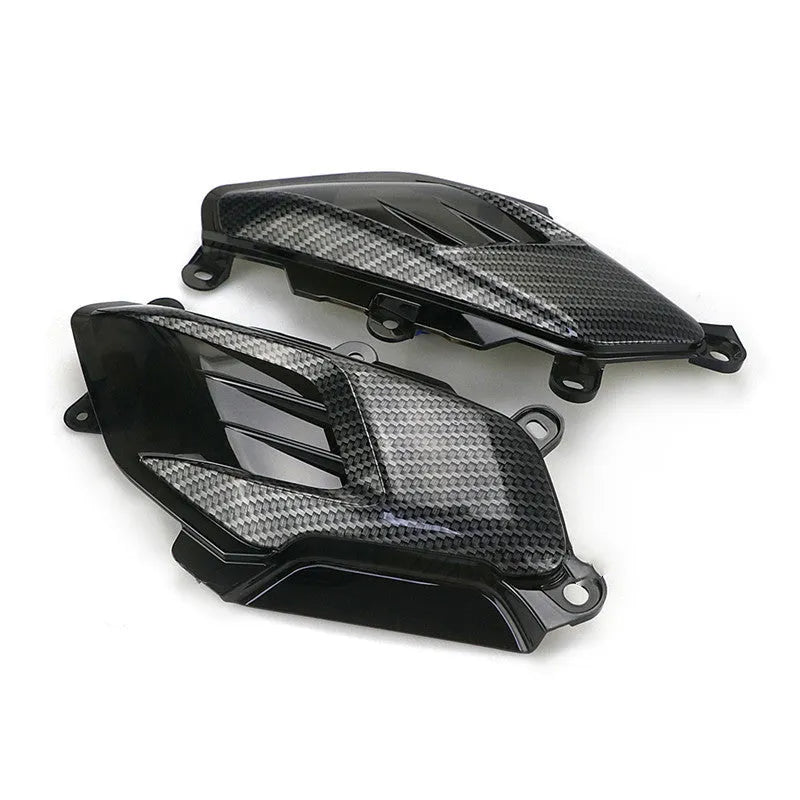 Pair of YAMAHA NMAX carbon fibre-look LED side lamp replacements on a blue background.