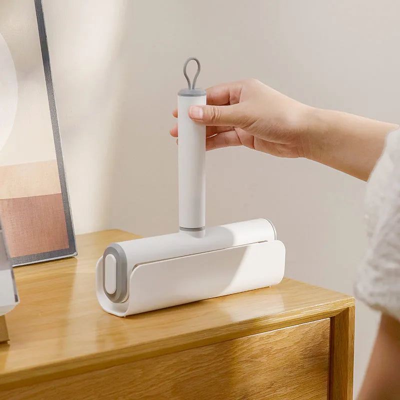 Refillable lint remover roller with tearable paper for pet hair removal on household surfaces