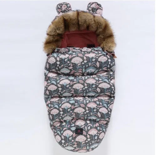 Baby warm cocoon style sleeping bag on a neutral background demonstrating solid colour design with zip closure