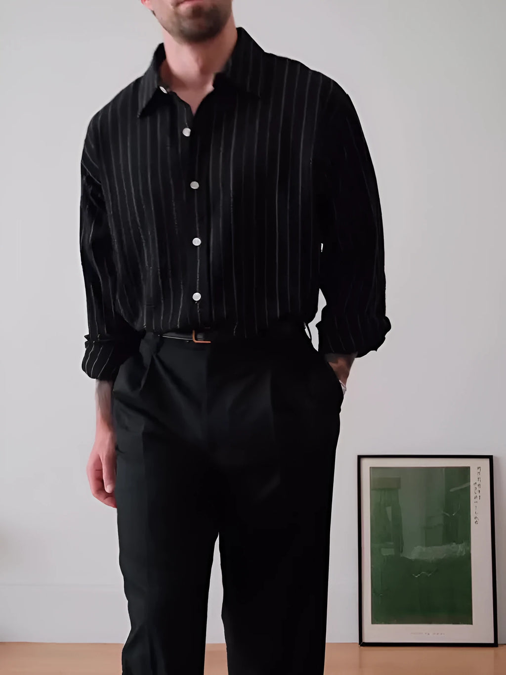 Men's black pinstriped button-down long sleeve shirt made from polyester fabric.