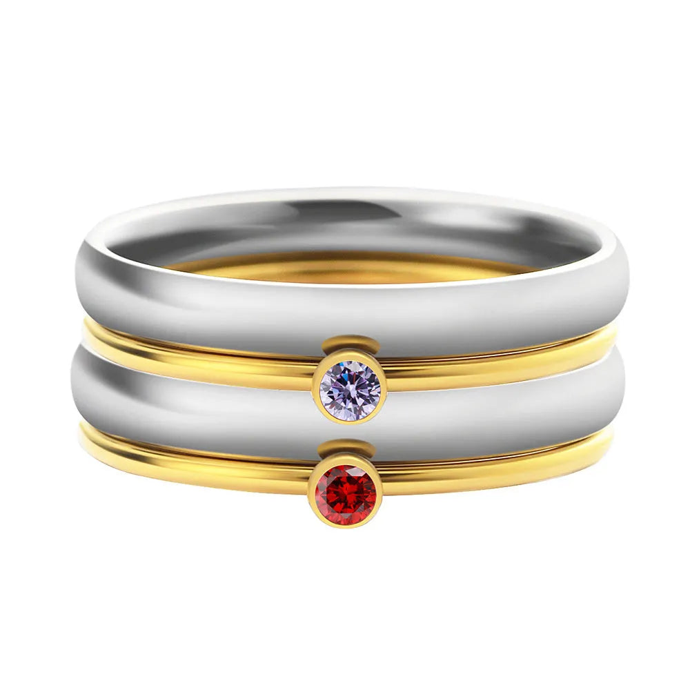 A geometric titanium steel ring with a December birthstone colour, gold electroplated handle, and engraved steel lettering.