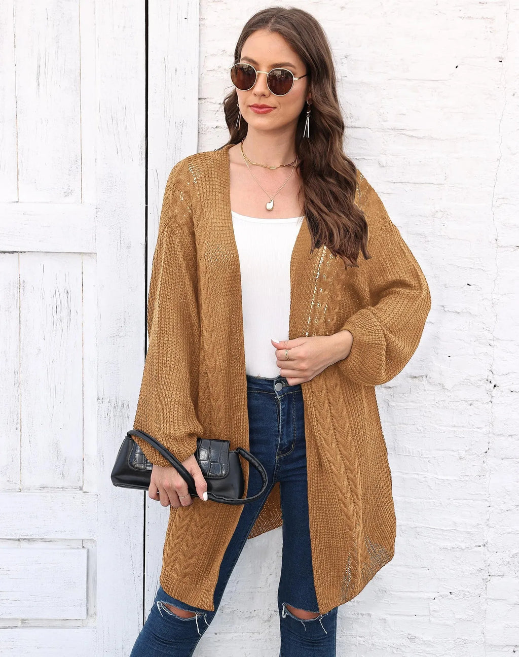 Women's loose longline acrylic cardigan sweater coat in a solid colour.
