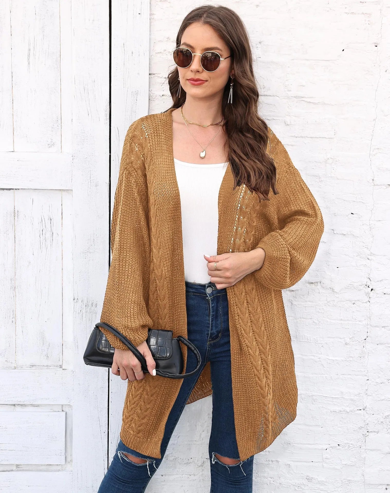 Women's loose longline acrylic cardigan sweater coat in a solid colour.