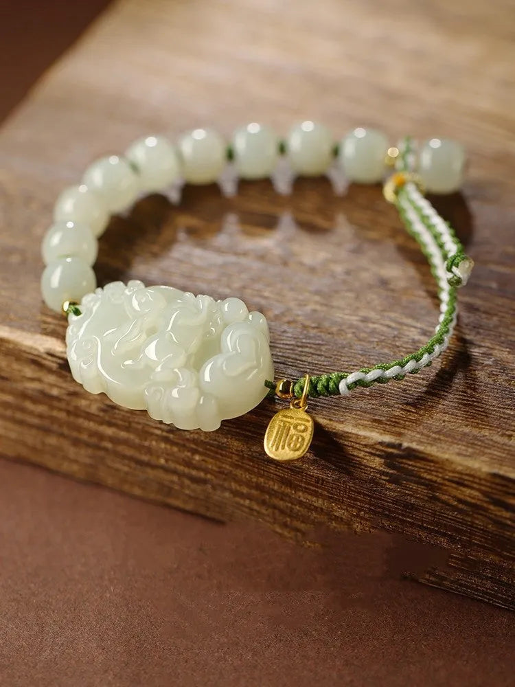 Hetian jade zodiac bracelet on red rope with S925 silver card for Chinese birth year animals.