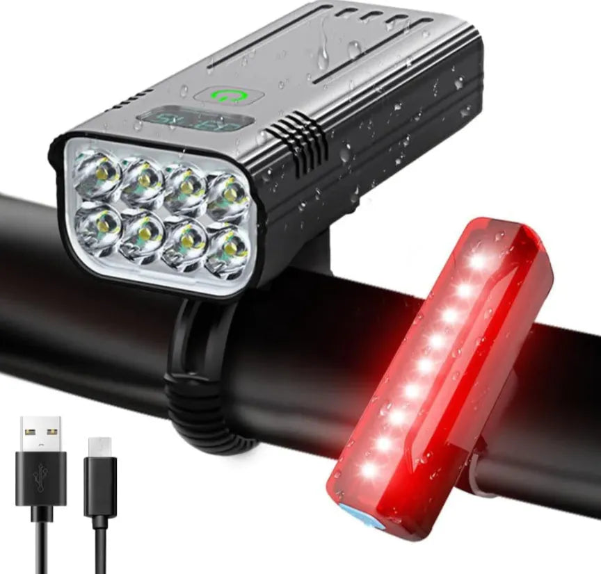 Black KX12DF digital display bicycle headlight with aluminium body mounted on bike handlebars via quick-release bracket.