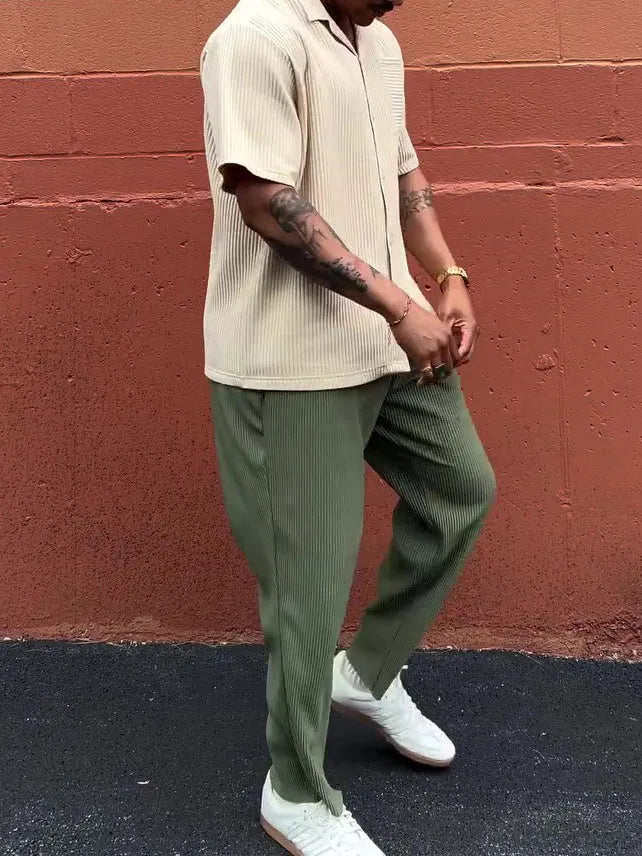 Green men's pleated casual trousers showing ankle-length cut and regular fit