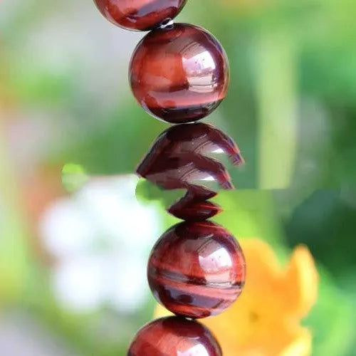 Wood alexandrite bracelet with red tigereye lightning cat's eye pattern and geometric round beads