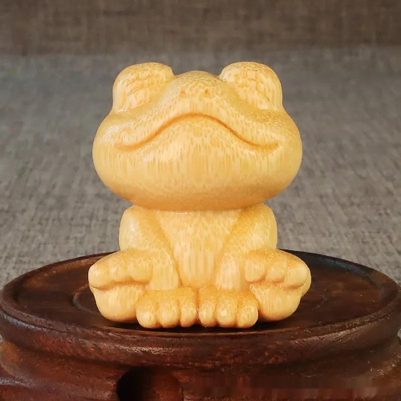 Solid bamboo carving ornament of a smiling frog, 5cm high, cute cartoon style.