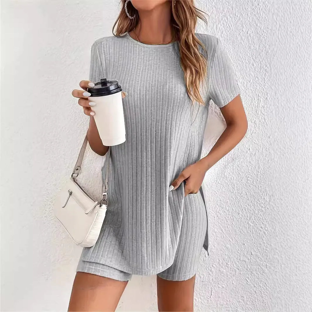 Women's coloured cotton lounge suit with crew neck top, shorts, and ribbed detail in grey.