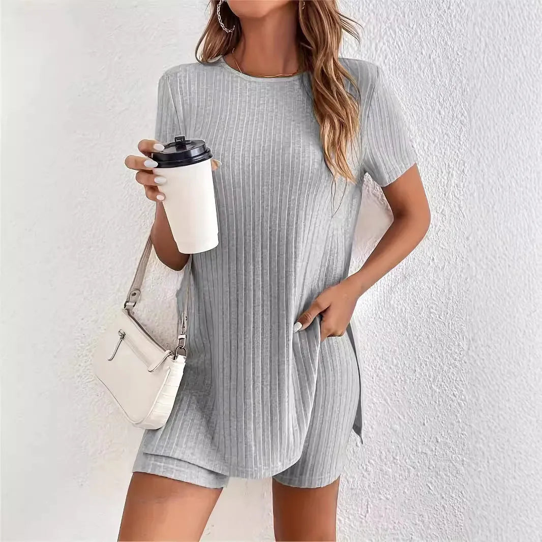 Women's coloured cotton lounge suit with crew neck top, shorts, and ribbed detail in grey.
