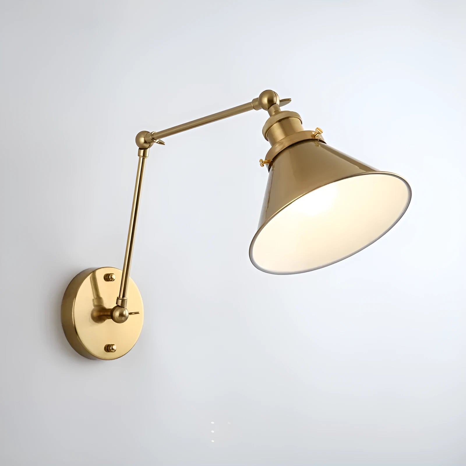Rocker arm wall lamp with retractable folding arm in iron shade, available in black, gold, or rust