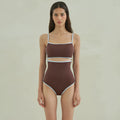 Brown women's triangle one-piece nylon swimsuit on a hanger.
