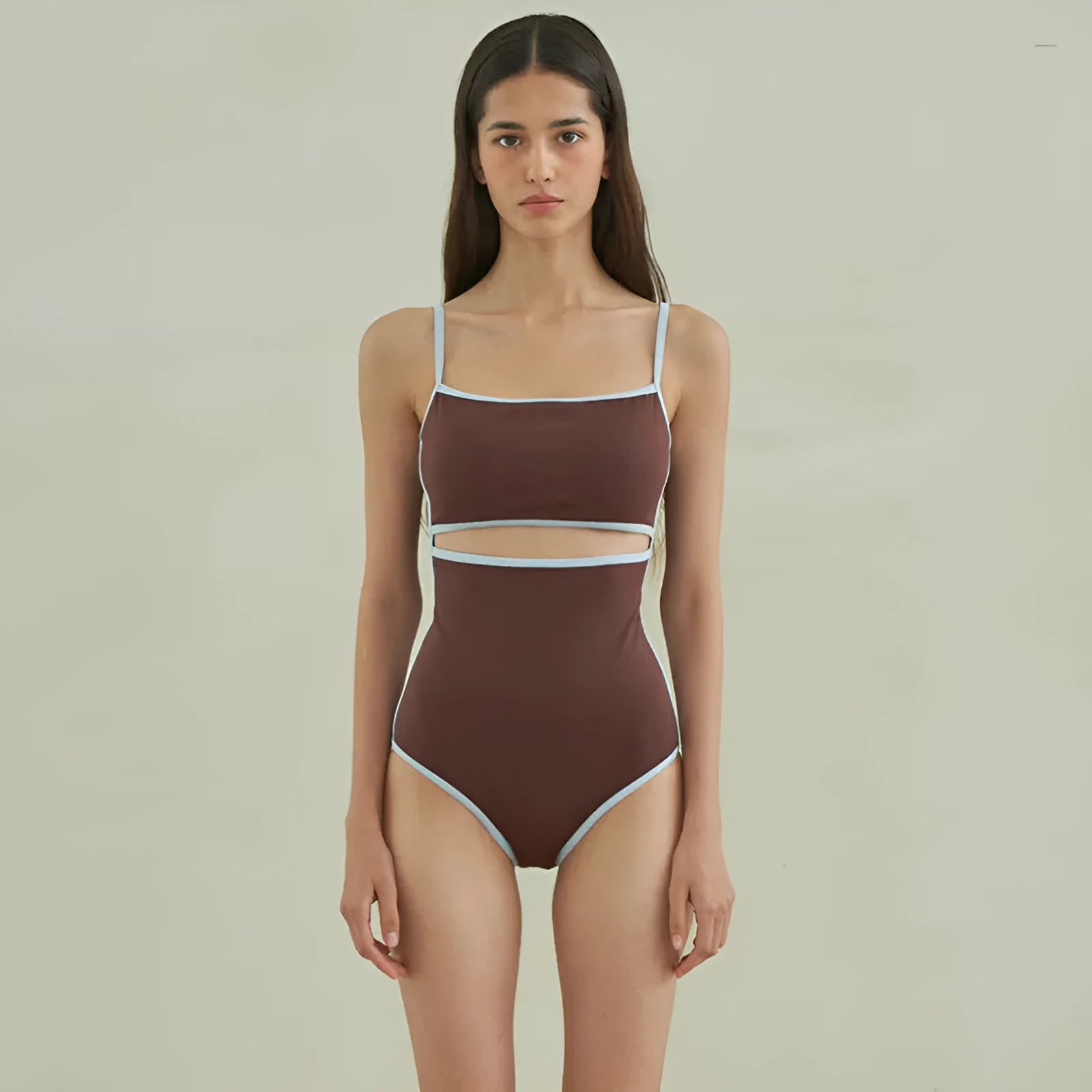 Brown women's triangle one-piece nylon swimsuit on a hanger.