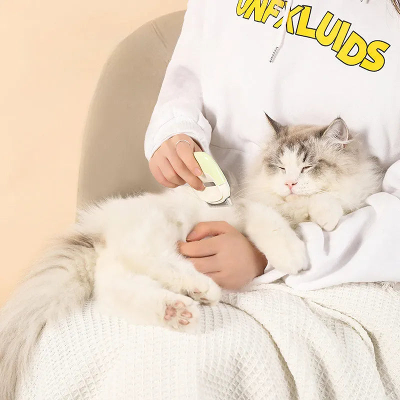 Blue dual-use pet grooming comb with cleaning needles for dogs and cats on a white background.