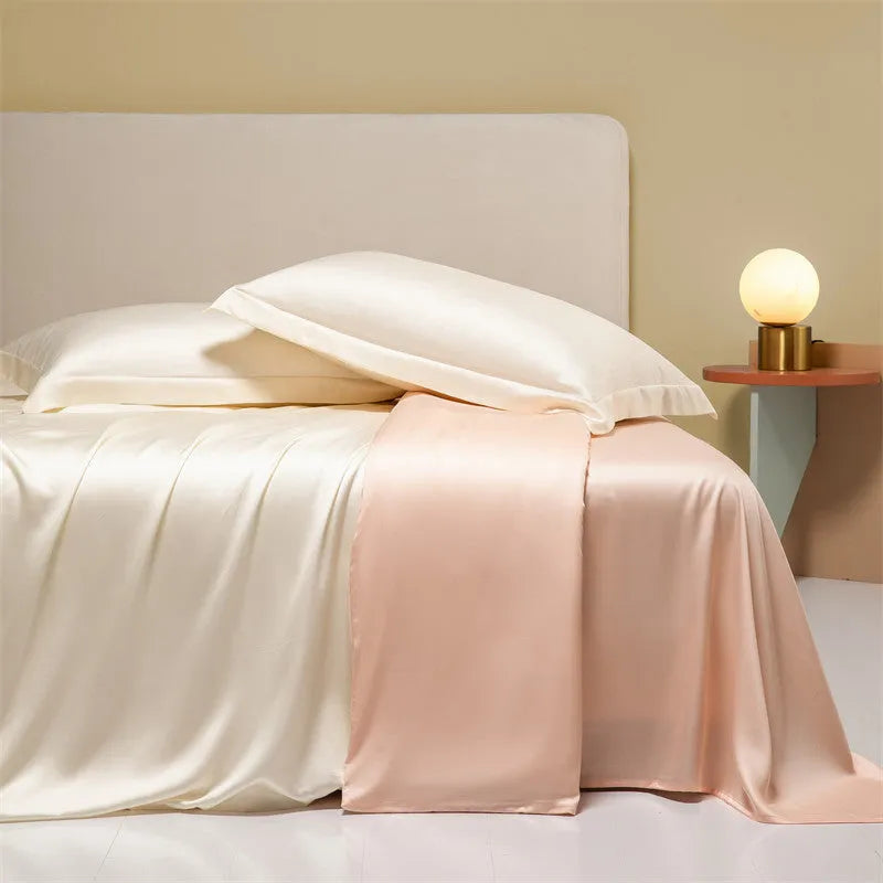 A neatly made bed with a Lenzing Tencel duvet cover and pillowcases in a soft grey colour.