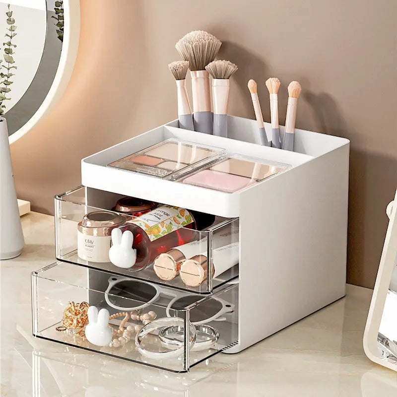 Transparent plastic desktop storage box with internal grid partitions, shown in pink colour.