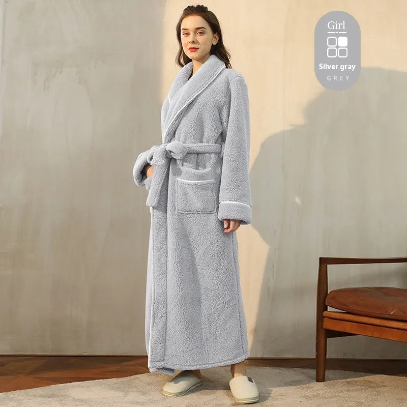 A man and woman wearing matching thick navy blue flannel bathrobes, ankle-length winter nightgown style.
