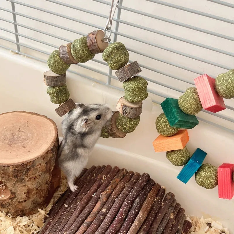 Hamster gnawing toy made of straw forming a ball ring, for small pets like guinea pigs.