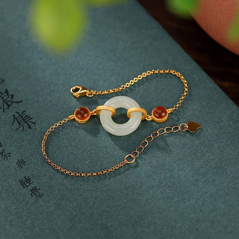 Women's S925 sterling silver gold-plated bracelet with inlaid natural Hetian jade and a peace buckle clasp.